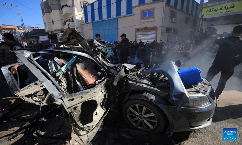 People check the vehicle damaged by an Israeli airstrike in the southern Gaza Strip city of Rafah, on Jan. 7, 2024. Two journalists were killed and another journalist was injured on Sunday in an Israeli airstrike targeting their vehicle in the southern Gaza Strip, according to Hamas media office. (Photo by Yasser Qudih/Xinhua)