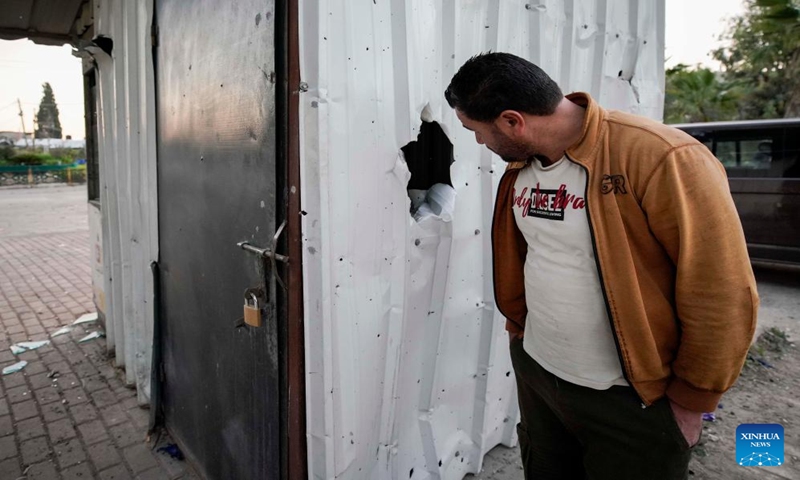 A man checks the site of a strike in the West Bank city of Jenin, Jan. 7, 2024. Seven Palestinians were killed on Sunday morning by an Israeli drone strike in the occupied West Bank, while an Israeli police officer was killed when her vehicle hit a roadside bomb, Israeli and Palestinian sources said on Sunday.(Photo by Ayman Nobani/Xinhua)