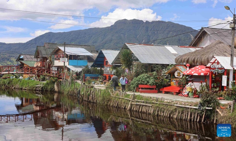 People take a walk by a river in El Encano in the department of Narino, Colombia, Jan. 5, 2024. (Xinhua/Zhou Shengping)