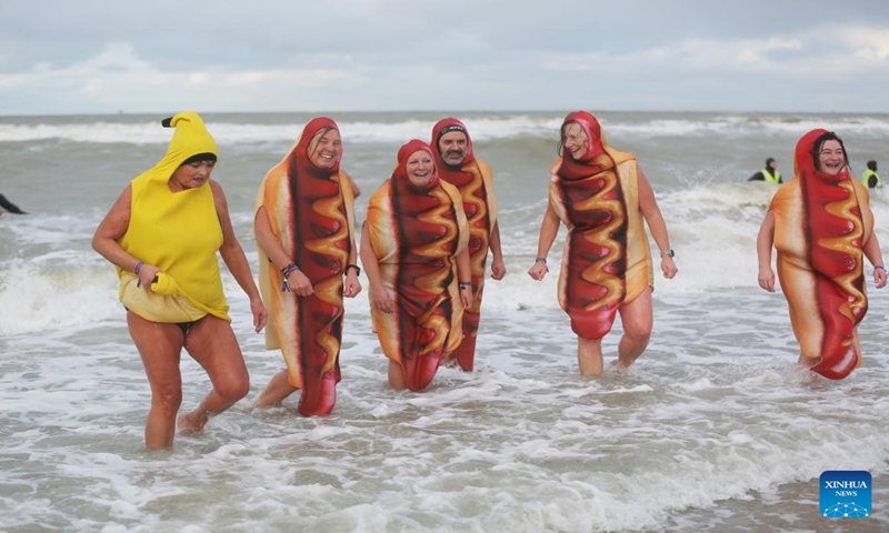 People in costumes take part in the traditional New Year's Dive in Ostend, Belgium, Jan. 6, 2024. Thousands of people braved the cold North Sea on Saturday to welcome the New Year. (Xinhua/Zhao Dingzhe)