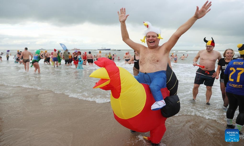 People take part in the traditional New Year's Dive in Ostend, Belgium, Jan. 6, 2024. Thousands of people braved the cold North Sea on Saturday to welcome the New Year. (Xinhua/Zhao Dingzhe)