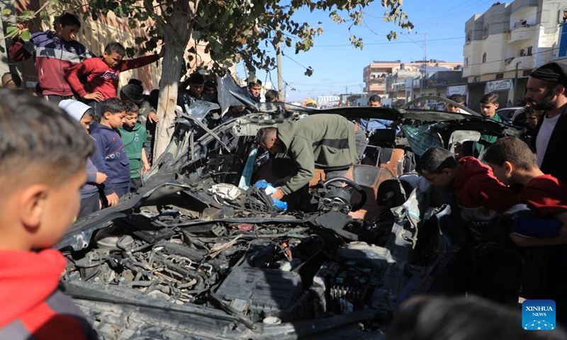 People check the vehicle damaged by an Israeli airstrike in the southern Gaza Strip city of Rafah, on Jan. 7, 2024. Two journalists were killed and another journalist was injured on Sunday in an Israeli airstrike targeting their vehicle in the southern Gaza Strip, according to Hamas media office. (Photo by Yasser Qudih/Xinhua)