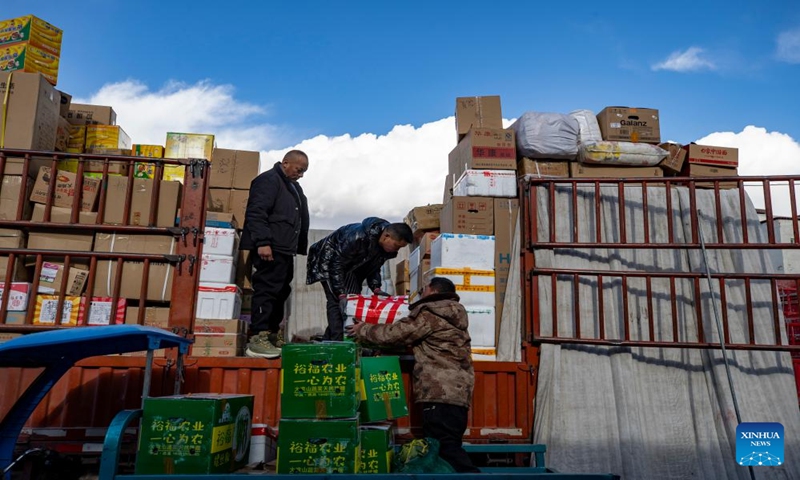 Staff members of Xainza County's Supply and Marketing Cooperative load goods to be delivered to remote towns in Xainza County onto a truck in Lhasa, southwest China's Xizang Autonomous Region, Jan. 2, 2024. The Xainza County in Nagqu City, southwest China's Xizang Autonomous Region, situated at an average elevation of 4,700 meters. Traditionally, local herders' diet relies on meat and tea, lacking fruits and vegetables.(Xinhua/Jiang Fan)