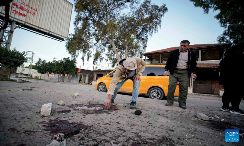 People check the site of a strike in the West Bank city of Jenin, Jan. 7, 2024. Seven Palestinians were killed on Sunday morning by an Israeli drone strike in the occupied West Bank, while an Israeli police officer was killed when her vehicle hit a roadside bomb, Israeli and Palestinian sources said on Sunday.(Photo by Ayman Nobani/Xinhua)