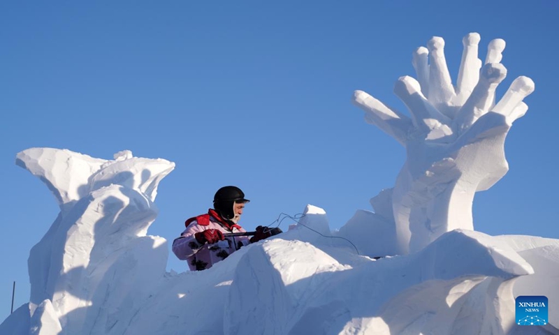 A contestant works on a snow sculpture at the Sun Island scenic area in Harbin, northeast China's Heilongjiang Province, Jan. 7, 2024. An international snow sculpture competition is held here, attracting snow sculptors from 12 countries. (Xinhua/Wang Jianwei)