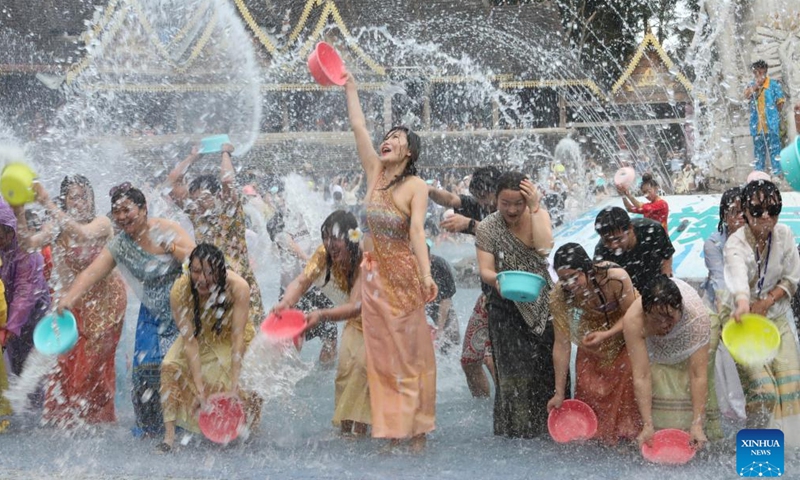 Tourists enjoy water-splashing at a Dai ethnic scenic spot in Jinghong City, southwest China's Yunnan Province, Jan. 7, 2024. Yunnan has attracted legions of tourists this winter due to its mild climate.(Photo: Xinhua)