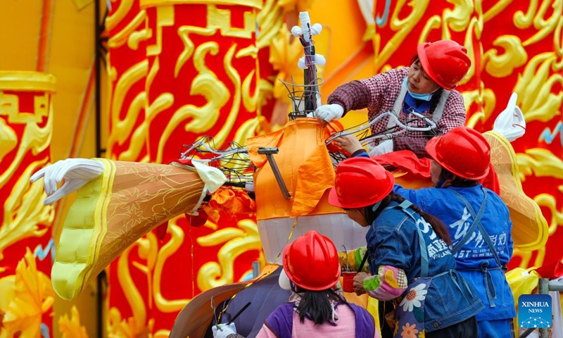 Staff members make a colored lantern at the site of upcoming lantern show in Zigong, southwest China's Sichuan Province, Jan. 18, 2024. The 30th International Dinosaur Lantern Show will kick off here on Feb. 2. (Xinhua/Shen Bohan)