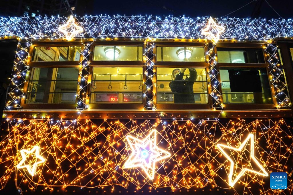 Tram driver Li Peng prepares for departure in Dalian, northeast China's Liaoning Province, Jan. 8, 2024. Since Dec. 31, 2023, several trams in Dalian have been decorated with lights in order to attract more tourists. The history of tram in Dalian City dates back to 1909. After more than 100 years of operation, the tram has become a popular icon of the city.(Photo: Xinhua)