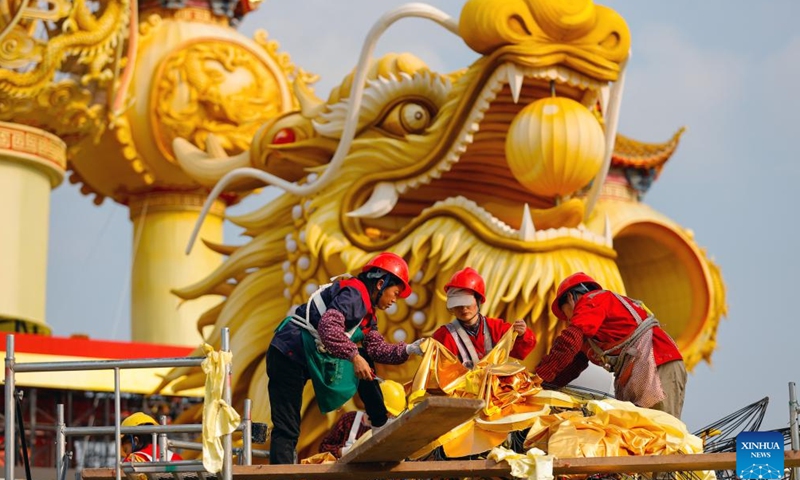 Staff members make a colored lantern at the site of upcoming lantern show in Zigong, southwest China's Sichuan Province, Jan. 18, 2024. The 30th International Dinosaur Lantern Show will kick off here on Feb. 2. (Xinhua/Shen Bohan)