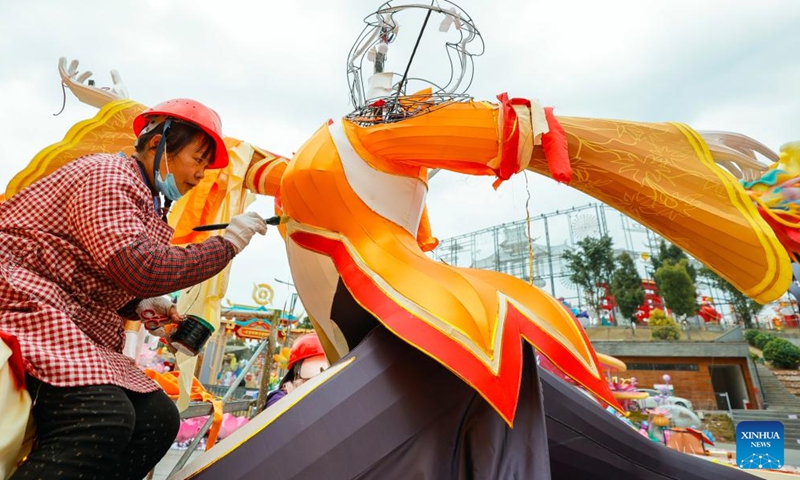 A staff member makes a colored lantern at the site of upcoming lantern show in Zigong, southwest China's Sichuan Province, Jan. 18, 2024. The 30th International Dinosaur Lantern Show will kick off here on Feb. 2. (Xinhua/Shen Bohan)