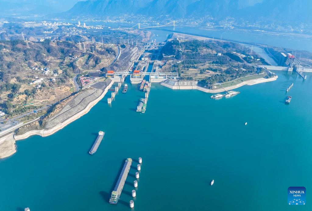 An aerial drone photo taken on Jan. 11, 2024 shows vessels passing through the five-tier ship locks of the Three Gorges Dam in Yichang, central China's Hubei Province. The cargo throughput via the Three Gorges Dam, the world's largest hydropower project on the upper stream of the Yangtze River, reached a record high of 172.34 million tonnes in 2023, up 7.95 percent year on year, according to the China Three Gorges Corporation.(Photo: Xinhua)