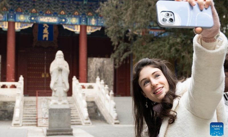 Carly Beth takes selfies at the Confucian Temple in Beijing, capital of China, Jan. 17, 2024.(Xinhua/Hu Zhixuan)