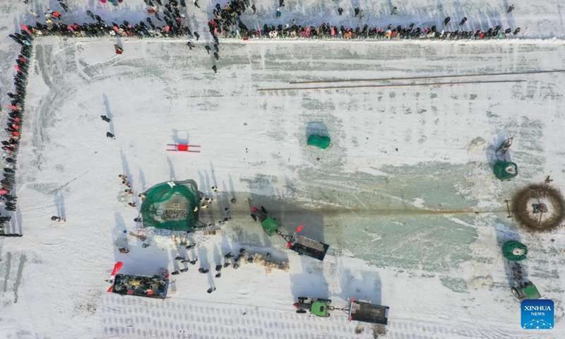 An aerial drone photo taken on Jan. 13, 2024 shows staff members catching fishes at a fishery of Dalinor Lake in Chifeng City, north China's Inner Mongolia Autonomous Region. A promotion event for tourism and winter fishing kicked off at the Dalinor Lake of Hexigten Banner in Chifeng. Featuring fishing, performance and other activities, this event attracted many tourists. (Xinhua/Liu Lei)