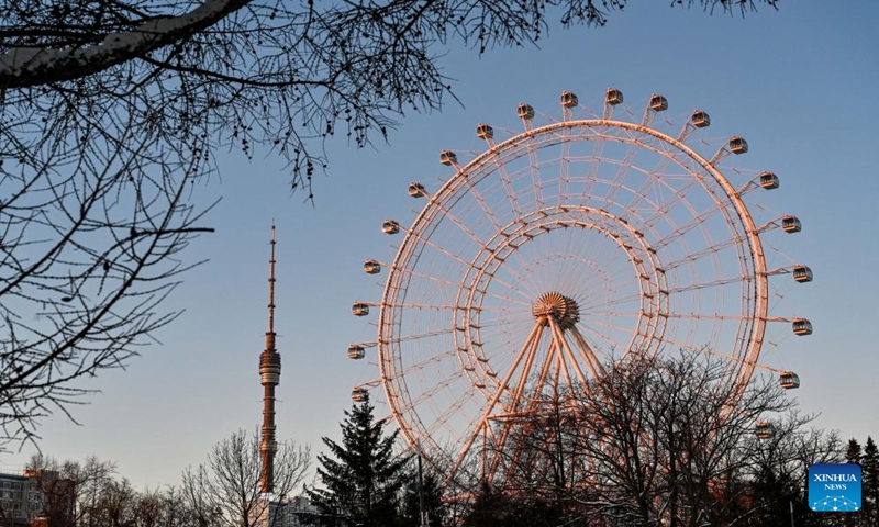 This photo taken on Jan. 13, 2024 shows the Ostankino television tower and a Ferris wheel in Moscow, Russia. (Xinhua/Cao Yang)