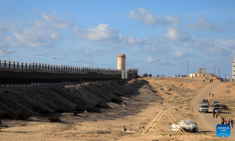 People walk on a road near the Gaza Strip's border with Egypt, Jan. 12, 2024. (Photo by Rizek Abdeljawad/Xinhua)