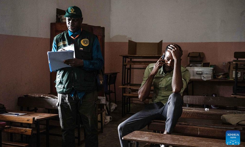 An election observer (L) takes notes of voting at a polling station in Mitsudje, Comoros, Jan. 14, 2024. Comoros kicked off its first round of the presidential election on Sunday to select the national leader from among six candidates, including incumbent President Azali Assoumani, for the next five years. (Xinhua/Wang Guansen)