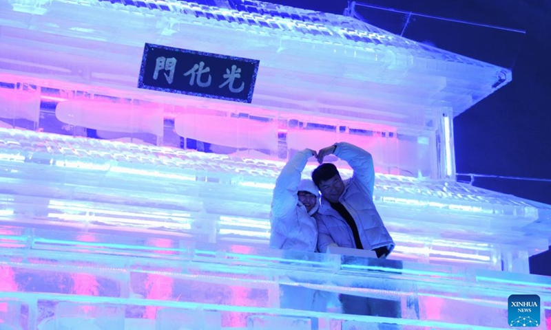 Tourists pose for pictures in front of the Gwanghwamun statues made by Harbin ice sculptors during Hwacheon Sancheoneo Ice Festival in Gangwon Province, South Korea, Jan. 13, 2024.  (Photo by Yang Chang/Xinhua)