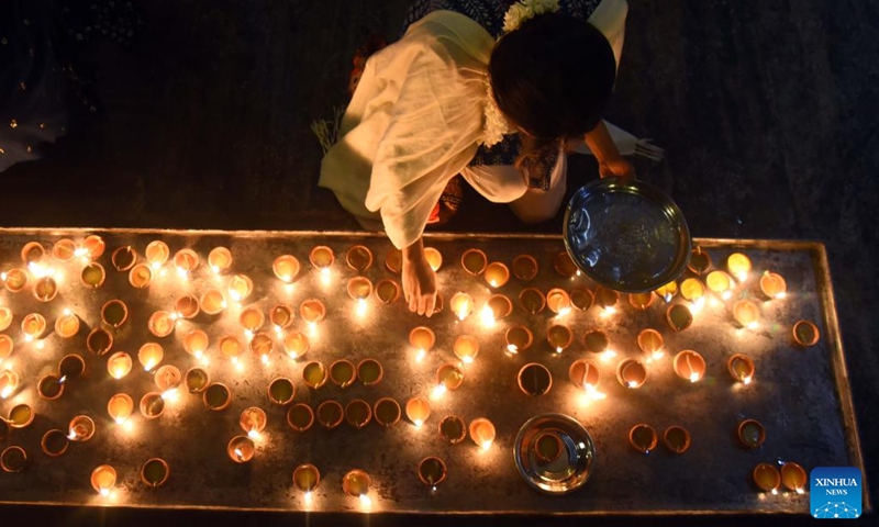 A devotee is seen lighting an oil lamp during the festival of Thai Pongal in Colombo, Sri Lanka, Jan. 15, 2024. Thai Pongal is a Tamil thanksgiving festival in celebration of a successful harvest.(Photo: Xinhua)