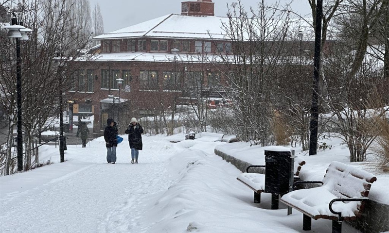 People walk on a road in Stockholm, Sweden on Jan. 17, 2024. Swedish authorities are going all-out to embrace a blizzard that is expected to hit most parts of the country on Wednesday afternoon.(Photo: Xinhua)