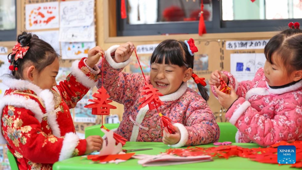 Children make paper cutting works at a kindergarten in Yuping Dong Autonomous County of Tongren City, southwest China's Guizhou Province, Jan. 16, 2024. Various events are held across the country in celebration of the upcoming Chinese Lunar New Year, which falls on Feb. 10 this year.(Photo: Xinhua)