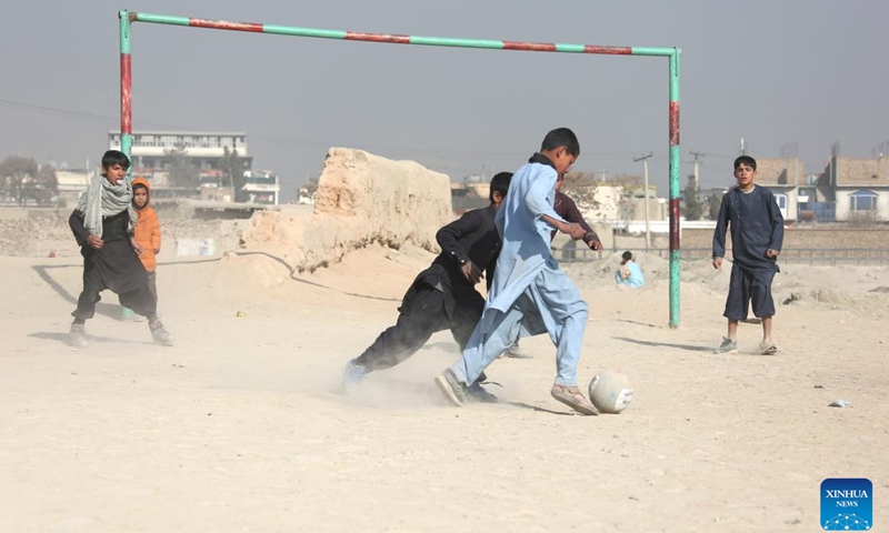Afghan boys play football in the cold weather on a dusty ground at the Alokhil village in Kabul, capital of Afghanistan, Jan, 16, 2024.(Photo: Xinhua)