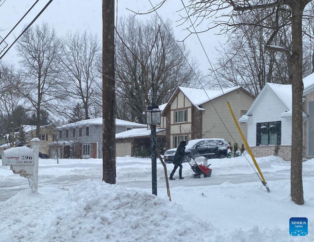 A resident removes snow with a snow blower in East Amherst, Erie county, New York State, the United States, on Jan. 18, 2024.(Photo: Xinhua)