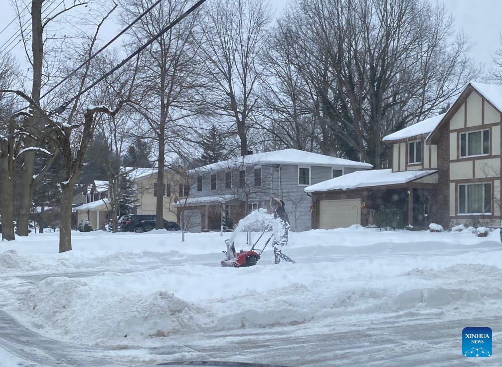 A resident removes snow with a snow blower in East Amherst, Erie county, New York State, the United States, on Jan. 18, 2024.(Photo: Xinhua)