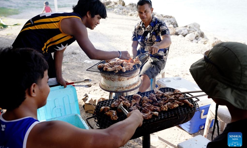 People barbecue at a beach in the Republic of Nauru, Jan. 20, 2024. (Xinhua/Wang Shen)