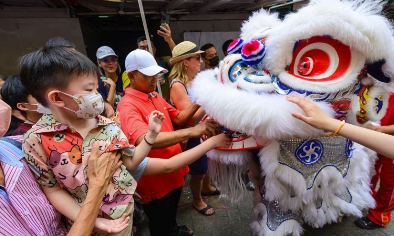 Members of a lion dance troupe perform during the Lantern Festival celebration at Petaling Street of Kuala Lumpur, Malaysia, Feb. 24, 2024. (Photo by Chong Voon Chung/Xinhua)