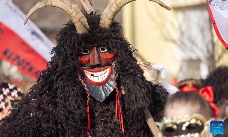 A Buso, costumed person wearing a wooden mask and a woolly cloak, takes part in the Buso Carnival in Mohacs, Hungary, on Feb. 13, 2024. The Buso festivities at Mohacs in southern Hungary are a six-day carnival in February to mark the end of winter, named for the busos, wearing wooden masks and big woolly cloaks. The folk tradition was inscribed on UNESCO's Representative List of the Intangible Cultural Heritage of Humanity in 2009. (Photo: Xinhua)