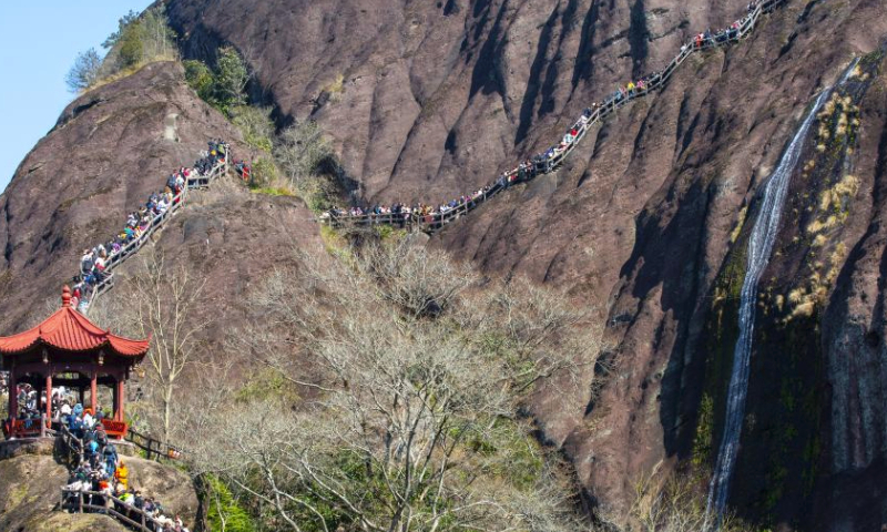 Tourists visit a scenic area of Wuyi Mountains in southeast China's Fujian Province, Feb. 11, 2024. Chinese people celebrate the Spring Festival through various ways during their holiday. (Photo by Chen Ying/Xinhua)