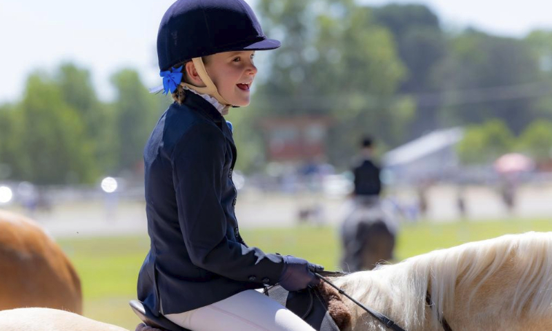 A girl rides a horse at the 2024 Royal Canberra Show in Canberra, Australia, Feb. 25, 2024. The Royal Canberra Show, staged annually by the Royal National Capital Agricultural Society, kicked off on Friday and concluded on Sunday this year. While having agriculture at its core, the show has broadened over the years to reflect more entertainment, educational features and exhibitions. (Photo by Chu Chen/Xinhua)