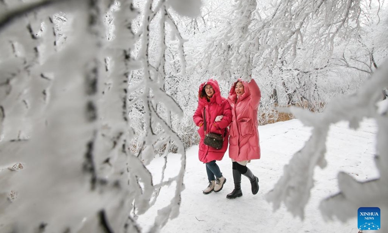 People enjoy the rime scenery at Yuntaishan Mountain upon the Sea scenic area in Lianyungang, east China's Jiangsu Province, Jan. 21, 2024. (Photo by Wang Jianmin/Xinhua)