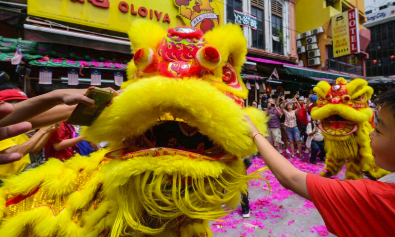 Members of a lion dance troupe perform during the Lantern Festival celebration at Petaling Street of Kuala Lumpur, Malaysia, Feb. 24, 2024. (Photo by Chong Voon Chung/Xinhua)