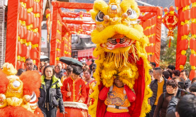 Tourists watch a lion dance in Bijie City, southwest China's Guizhou Province, Feb. 11, 2024. Chinese people celebrate the Spring Festival through various ways during their holiday. (Photo by Luo Dafu/Xinhua)