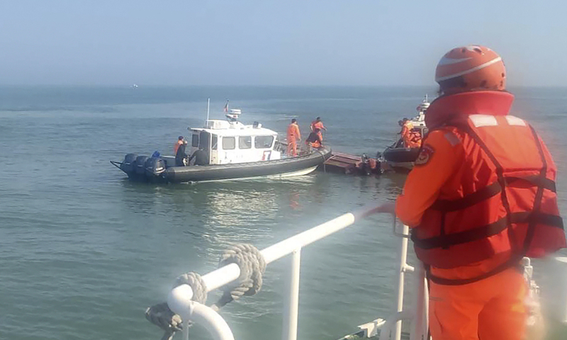 Personnel from Taiwan's coast guard authority inspect a boat that was capsized in the waters near Kinmen on February 14, 2024. Photo: VCG