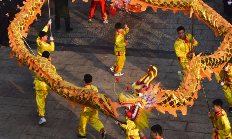 Folk artists perform dragon dance during a temple fair held in Xunxian County of central China's Henan Province, Feb. 25, 2024. Local residents of Shehuo performing teams participated in a temple fair in Xunxian on Sunday, one day after the Chinese Lantern Festival. Shehuo is a traditional carnival-like folk celebration, featuring performances like dragon dance, lion dance, traditional Chinese opera, drum playing and other folk performances that may vary in different regions. (Xinhua/Zhu Xiang)