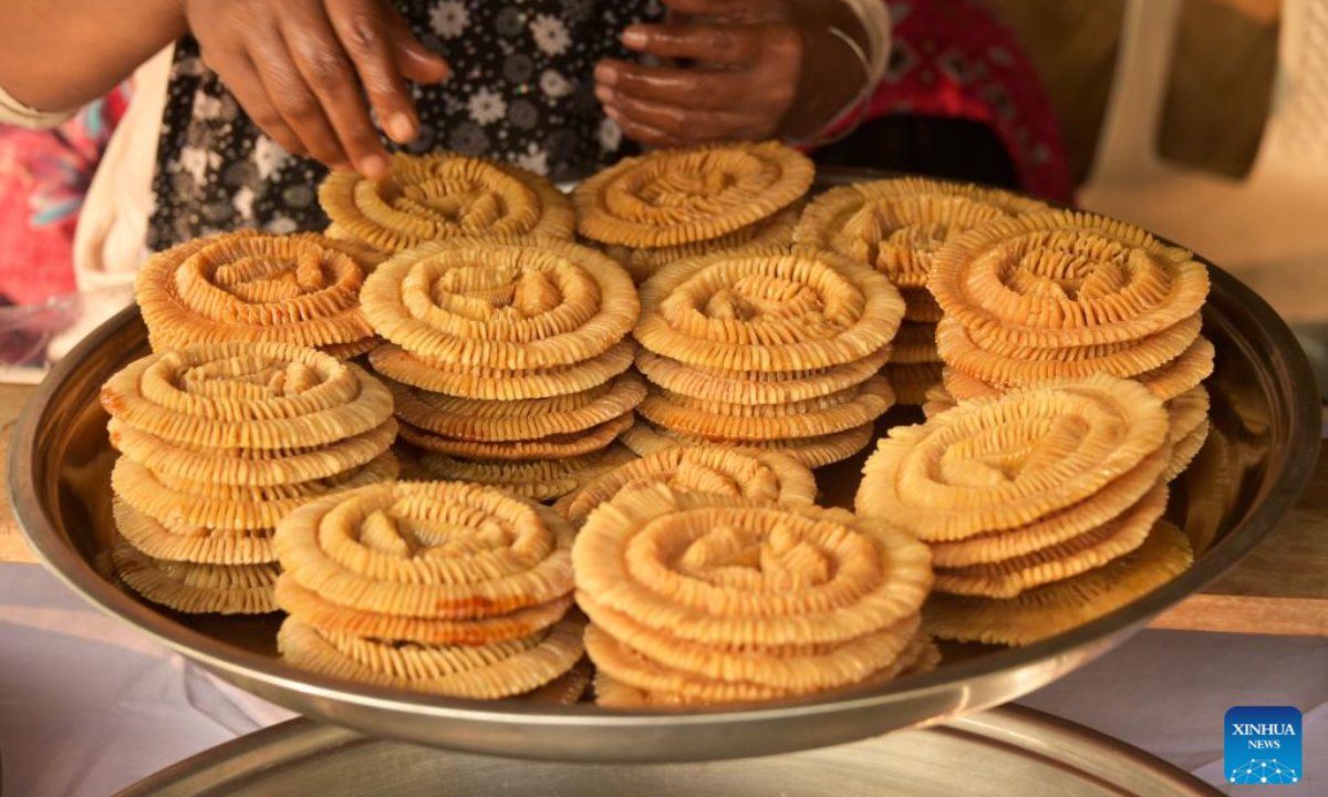 A vendor displays a type of Pitha for sale during a festival in Dhaka, Bangladesh, Jan 31, 2024. Photo:Xinhua