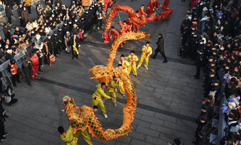 Folk artists perform dragon dance during a temple fair held in Xunxian County of central China's Henan Province, Feb. 25, 2024. Local residents of Shehuo performing teams participated in a temple fair in Xunxian on Sunday, one day after the Chinese Lantern Festival. Shehuo is a traditional carnival-like folk celebration, featuring performances like dragon dance, lion dance, traditional Chinese opera, drum playing and other folk performances that may vary in different regions. (Photo by Zhang Tingyuan/Xinhua)