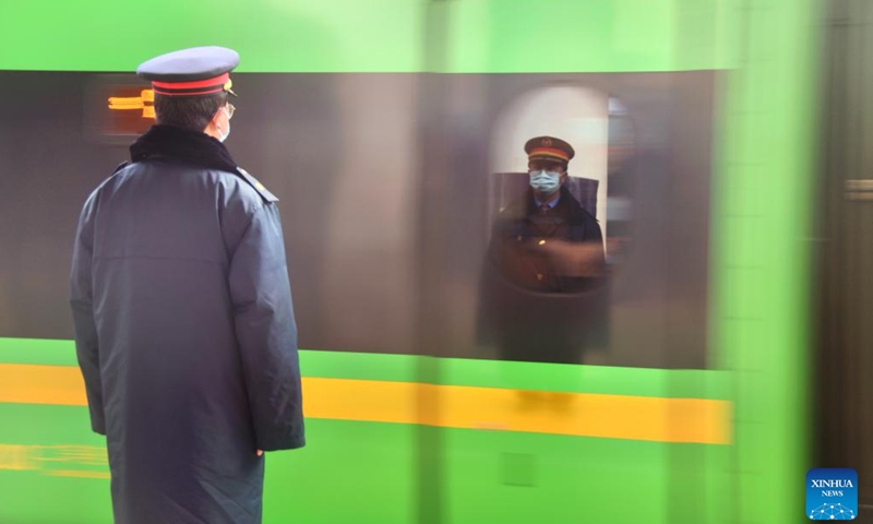 A staff member views the train departing at Xigaze Station in Xigaze, southwest China's Xizang Autonomous Region, Jan. 27, 2024. China officially ushered in its largest annual population migration on Friday, 15 days ahead of the Spring Festival, or the Lunar New Year, with record-breaking journey numbers expected. (Xinhua/Liu Wenbo)