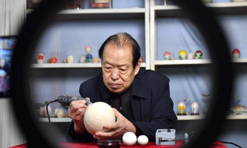 Craftsman Zheng Qingshan demonstrates eggshell carving techniques via live streaming in Feixiang District, Handan City, north China's Hebei Province, Feb. 19, 2024. During the Spring Festival, a series of live streaming events were held in Feixiang District of Handan, introducing the Chinese intangible cultural heritages like eggshell carving and wood carving to netizens. (Xinhua/Wang Xiao)