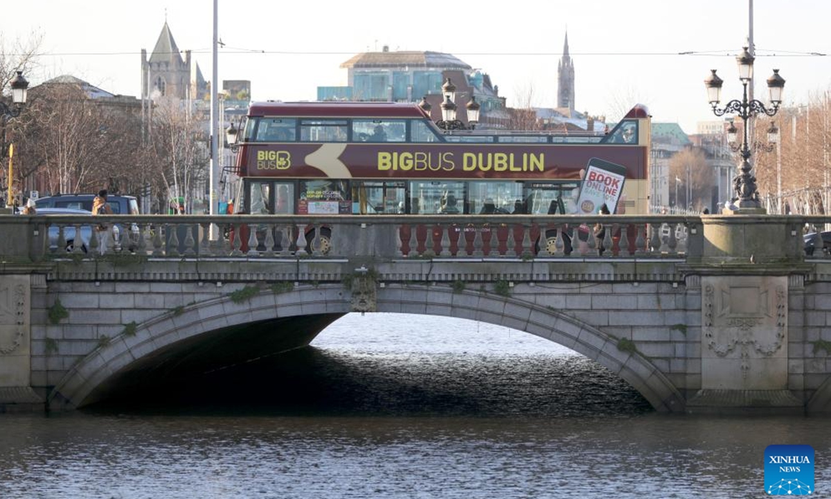 A double-decker bus passes a bridge in Dublin, Ireland, Jan. 15, 2024. (Xinhua/Li Ying)