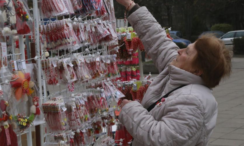 A stall owner arranges Martenitsi for sales in Sofia, Bulgaria, March 1, 2024. Bulgarian people marked the day named Baba Marta on Friday. On that day and a few days afterwards, Bulgarians exchange and wear the so-called Martenitsa - a small piece of adornment, made of white and red yarn. (Xinhua/Lin Hao)