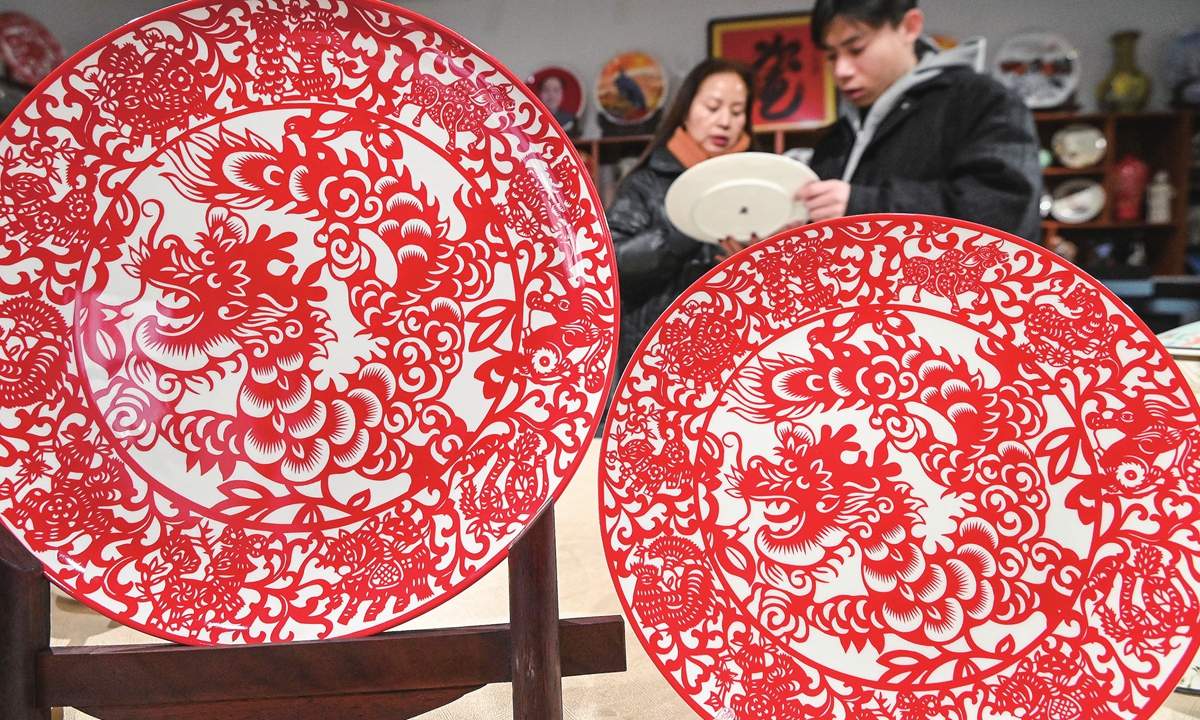 People examine dragon-themed ceramic products in an exhibition hall of a ceramic company in Handan, North China's Hebei Province on January 22, 2024. As the Year of the Dragon is right around the corner, the consumer frenzy around products characterized by the auspicious mythical creature is already palpable. Photo: VCG