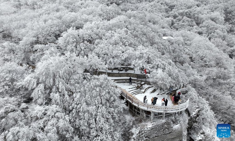 An aerial drone photo shows people enjoying the rime scenery at Yuntaishan Mountain upon the Sea scenic area in Lianyungang, east China's Jiangsu Province, Jan. 21, 2024. (Photo by Wang Chun/Xinhua)