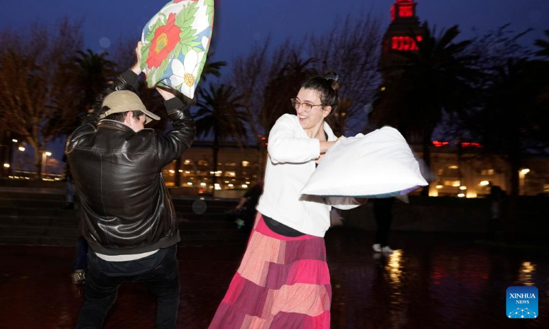 People participate in an annual pillow fight in San Francisco, the United States, Feb. 14, 2024. (Photo by Li Jianguo/Xinhua)