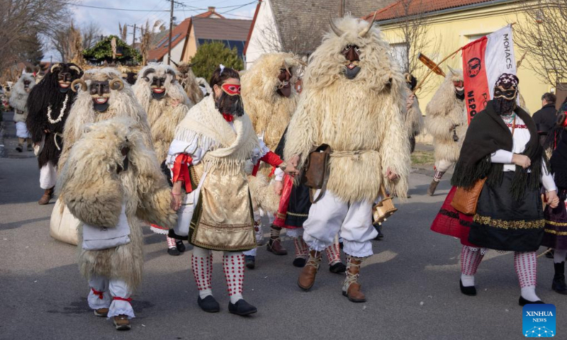 Busos, costumed people wearing wooden masks and woolly cloaks, take part in the Buso Carnival in Mohacs, Hungary, on Feb. 13, 2024. The Buso festivities at Mohacs in southern Hungary are a six-day carnival in February to mark the end of winter, named for the busos, wearing wooden masks and big woolly cloaks. The folk tradition was inscribed on UNESCO's Representative List of the Intangible Cultural Heritage of Humanity in 2009. (Photo: Xinhua)