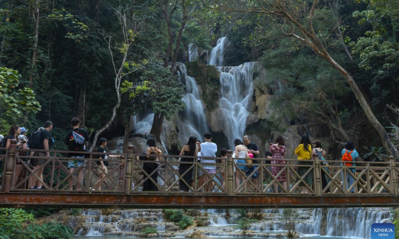 Tourists visit a waterfall in Luang Prabang, Laos, Feb. 16, 2024. The China-Laos Railway is witnessing its first Spring Festival travel rush since the railway started cross-border passenger services on April 13, 2023. Laos embraced a boost in tourism thanks to the passenger flow brought by the China-Laos Railway during the Spring Festival holiday. (Photo by Kaikeo Saiyasane/Xinhua)