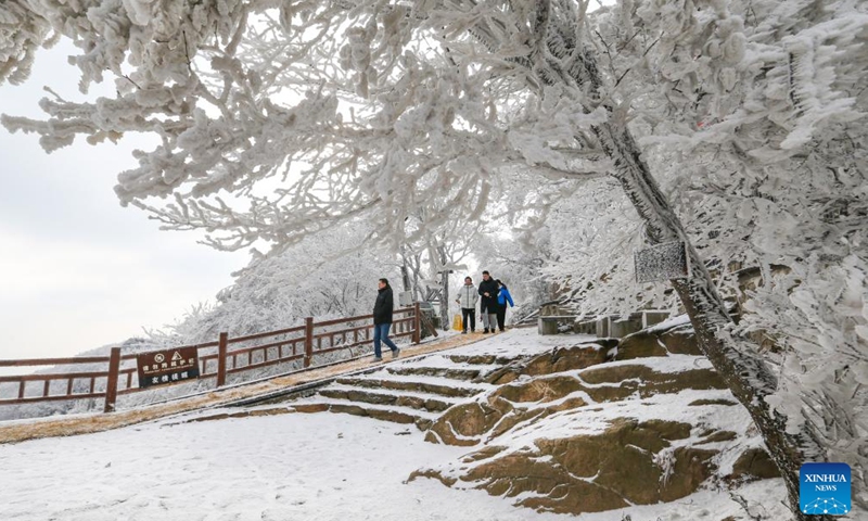 People enjoy the rime scenery at Yuntaishan Mountain upon the Sea scenic area in Lianyungang, east China's Jiangsu Province, Jan. 21, 2024. (Photo by Wang Jianmin/Xinhua)