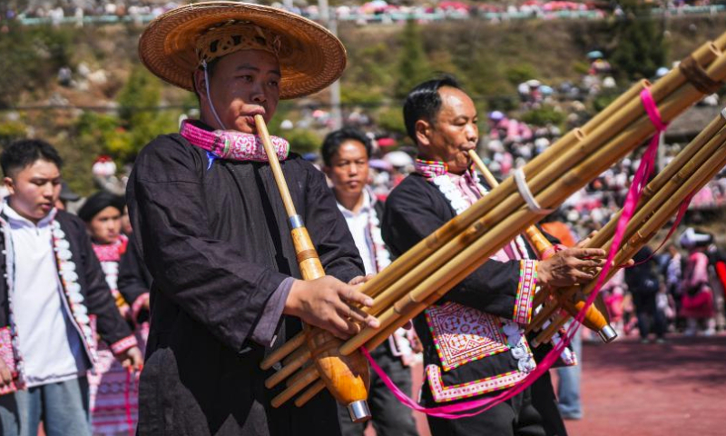 People of Miao ethnic group communicate during a celebration of Tiaohua festival in Gaoxing Village of Liuzhi Special District, Liupanshui, southwest China's Guizhou Province, Feb. 19, 2024. People of Miao ethnic group celebrated the Tiaohua festival here on Monday to pray for the harvest and well-being in the new year. (Xinhua/Tao Liang)